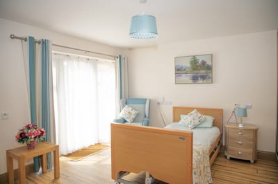 A well-furnished private resident room with a sunny view