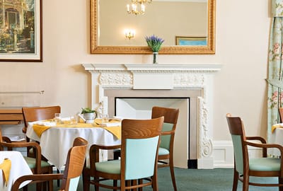 Elegant dining area with tables and a decorative fireplace