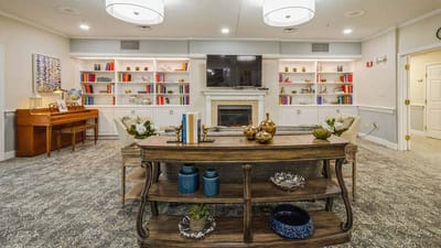 Cozy common area with bookshelves and piano