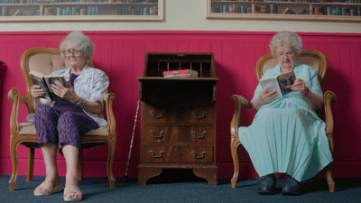 Two residents reading in a common area