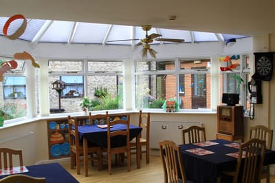 Bright sunroom with tables and chairs