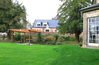 Outdoor garden area with a wooden pergola