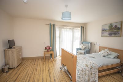 A well-furnished private resident room with natural light