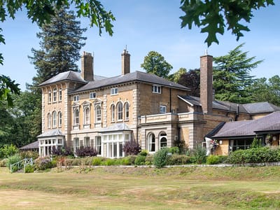 Exterior view of Merlewood Care Home surrounded by gardens