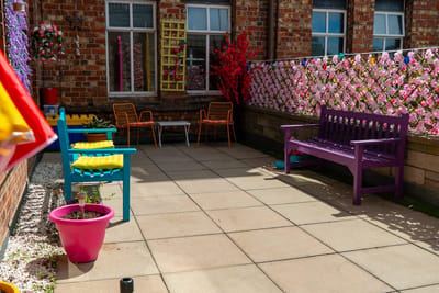 Colorful outdoor seating area with plants and decorations