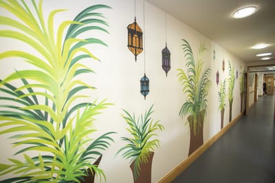 Interior hallway with decorative palm plant mural