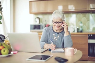 Senior woman engaged in conversation at a desk