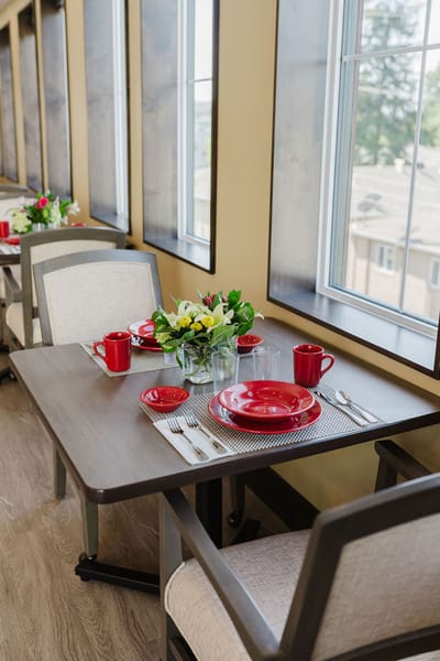 Dining table set for a meal in a sunny dining room