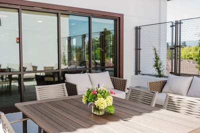 Outdoor seating area with flowers and furniture