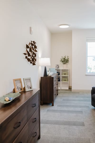 Interior view of a resident room with furniture and decor