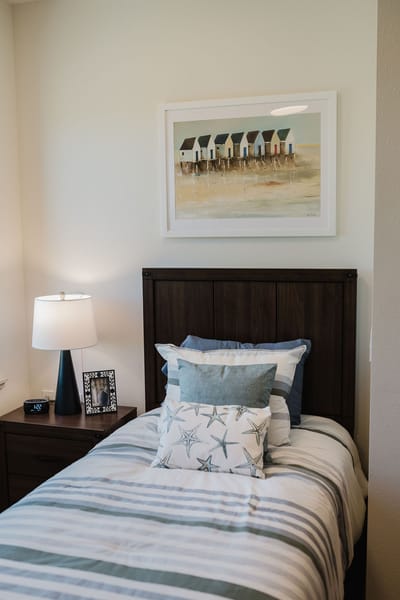 Cozy private room with bedside lamp and artwork