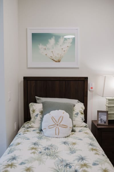 Cozy resident room with floral bedding and artwork