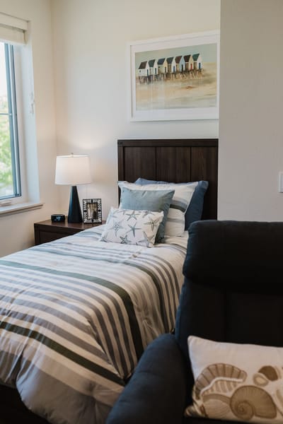 Cozy resident room with a bed and comfortable chair