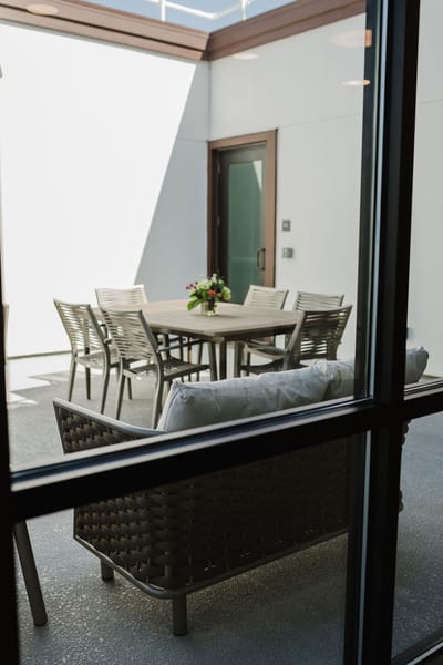 Outdoor seating area with a table and flowers