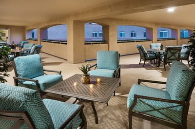 Outdoor seating area with blue chairs and plants