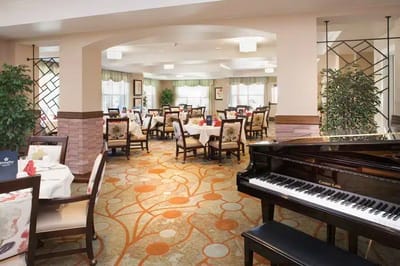 Elegant dining room with piano at MorningStar of Boulder