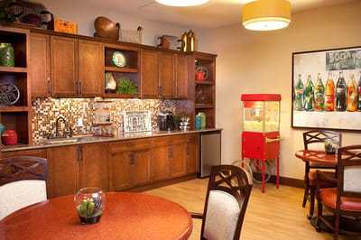 Bright common area with kitchen amenities and seating