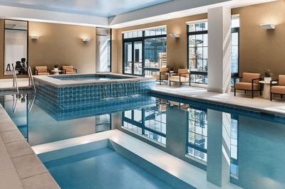 Indoor swimming pool area with lounge chairs