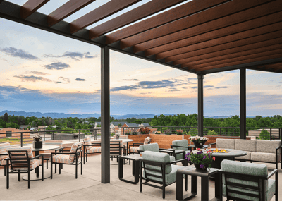 Outdoor seating area with mountain view at sunset