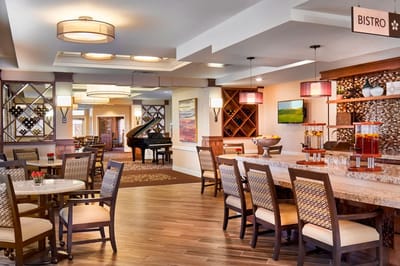Interior view of dining area with seating and a piano