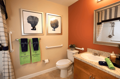 Well-decorated bathroom with safety features and plants