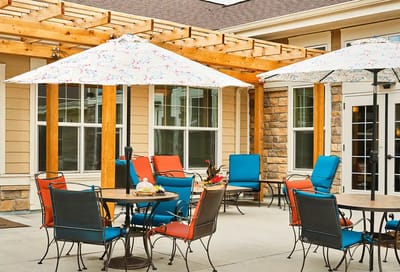 Outdoor patio area with colorful seating and umbrellas