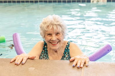 Resident enjoying a swim in the pool