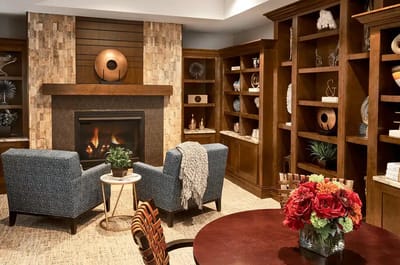 Cozy common area with seating and decorative shelves