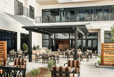 Outdoor seating area with shaded pergola and chairs
