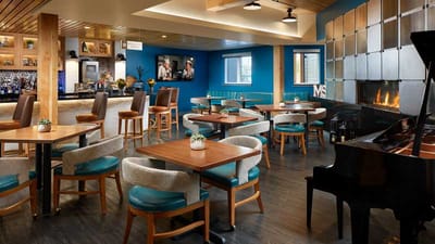 Interior dining area with tables and a piano