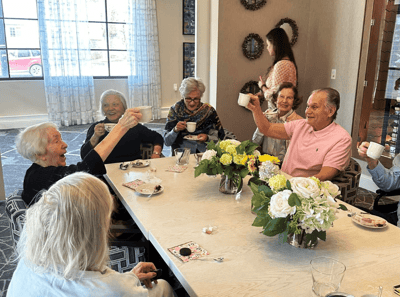 Residents enjoying refreshments and socializing in a common area