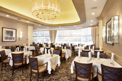 Elegant dining room with set tables and chandeliers