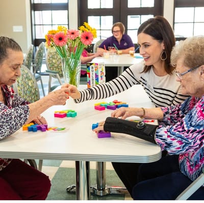 Residents engaging in a colorful activity with staff