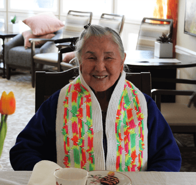 Senior resident smiling in a cozy common area