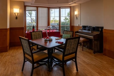 Common area with tables and a piano