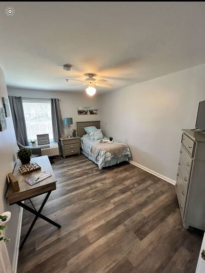 Bright interior view of a resident's room with furnishings
