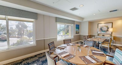 Dining room with a well-set table and natural light