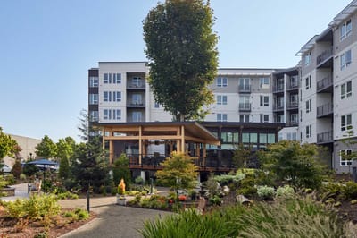Outdoor view of a senior living facility with gardens