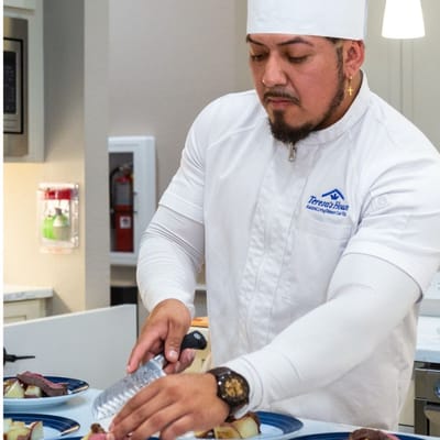 Chef preparing a meal in the kitchen