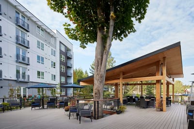 Outdoor seating area with a large structure and trees