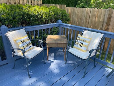 Outdoor seating area with pillows on chairs