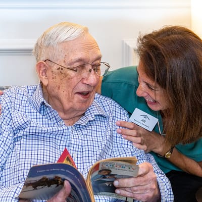 Staff member reading with a resident