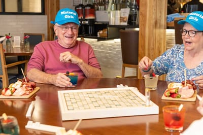 Residents enjoying a game while having cocktails and snacks