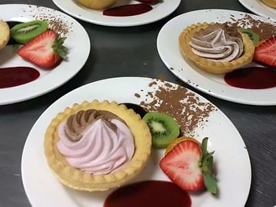 Exquisite desserts with fruits on plates