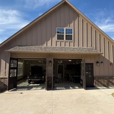 Exterior view of the facility with open garage doors