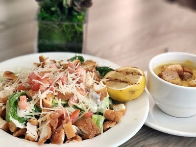 A salad and soup served in a dining area