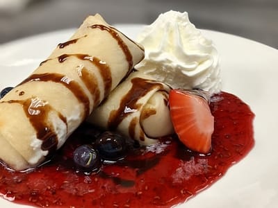 Gourmet dessert served with berries and whipped cream