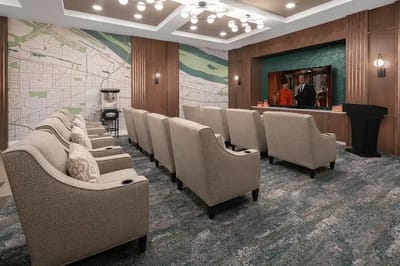A cozy common area with seating and a TV for residents