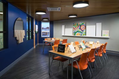 Bright activity room with tables and chairs
