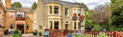 Exterior view of Primrose Croft Care Home with outdoor space